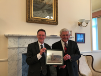Eric Baxter, left, receives a small gift from Provost Brennan